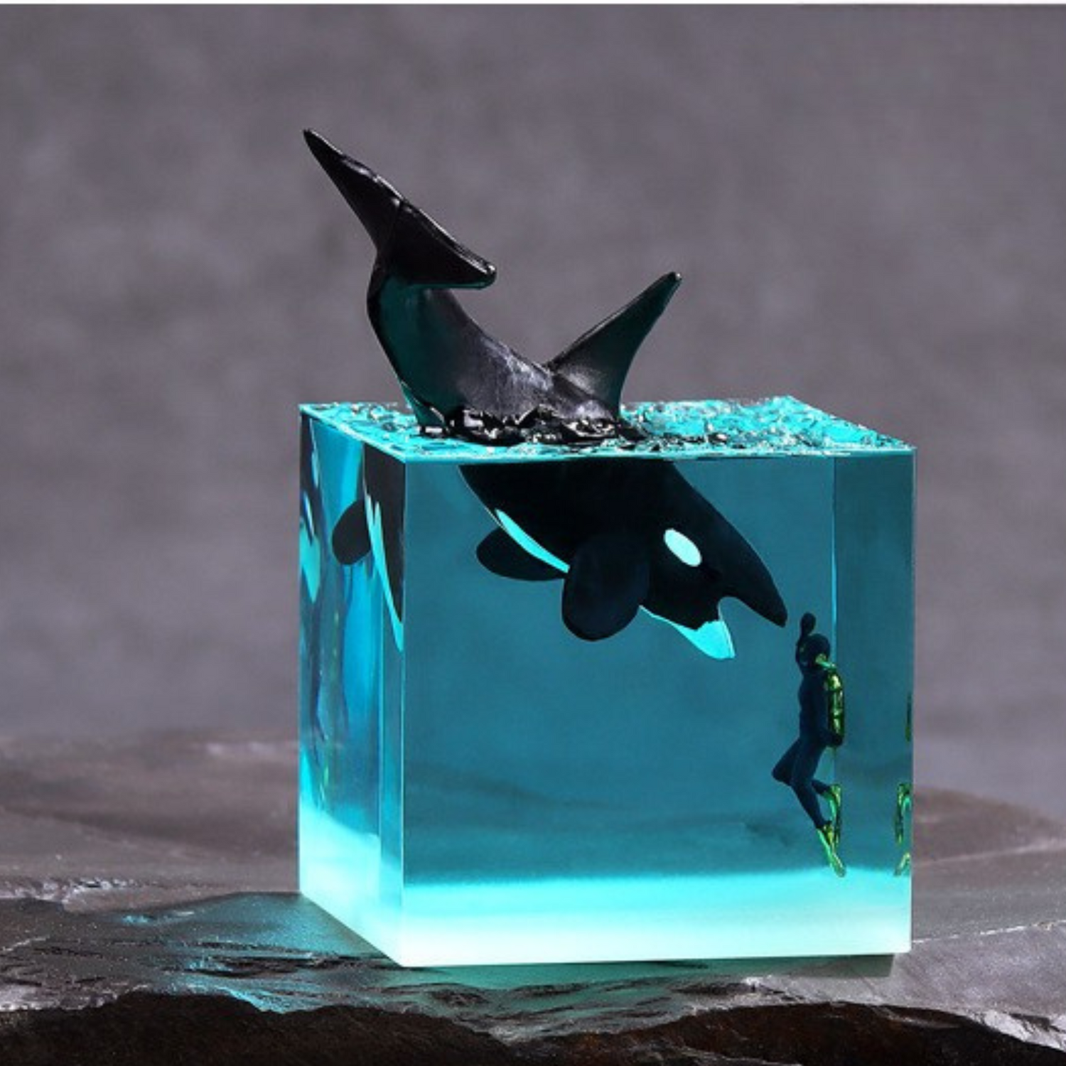 Handmade resin cube decoration featuring a whale leaping into the ocean